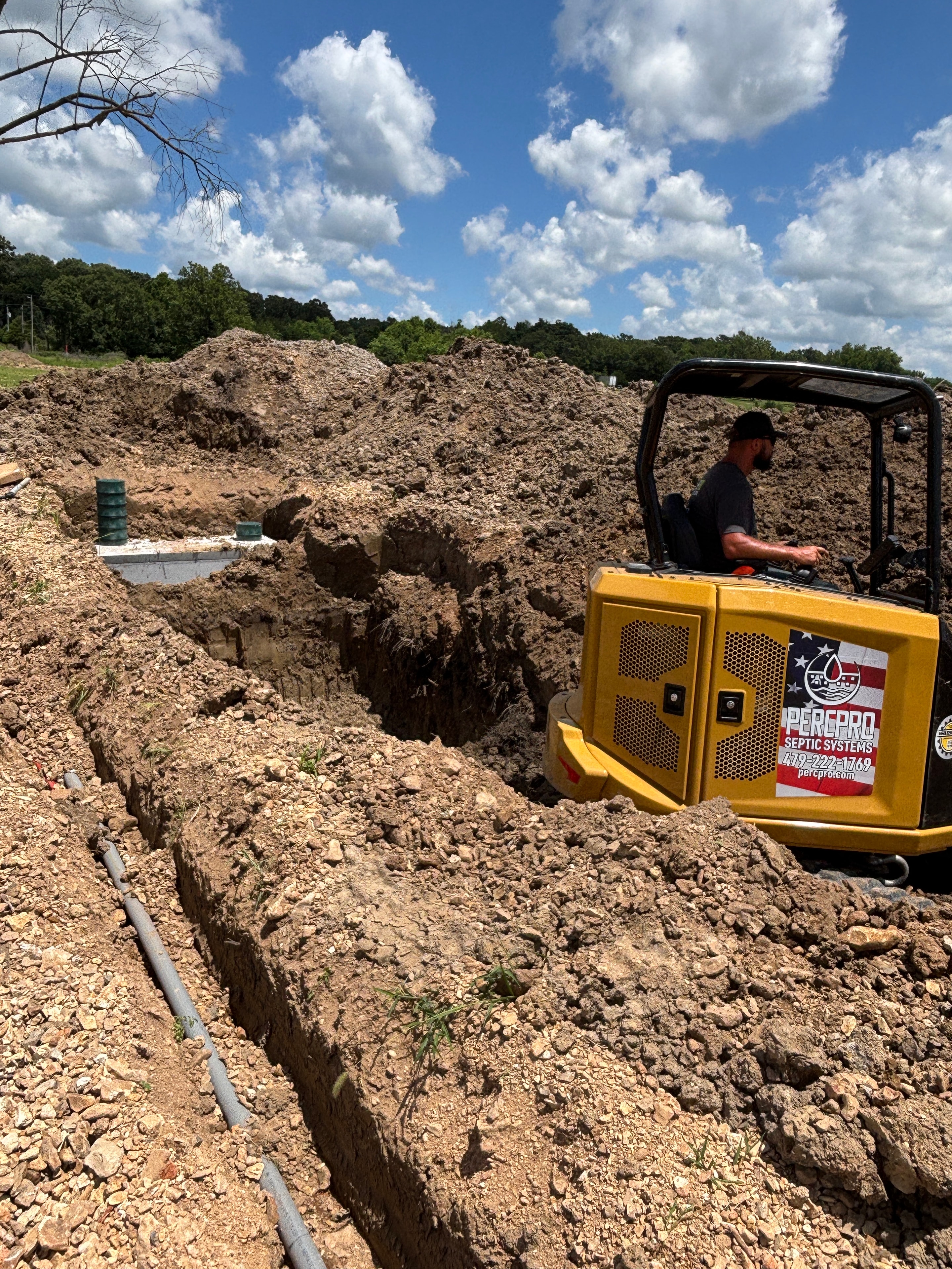 PercPro yellow excavator digging