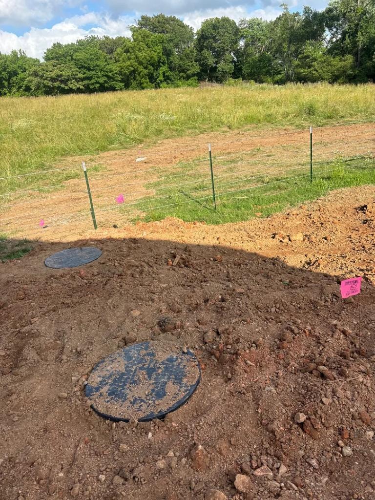 Freshly installed PercPro septic system showing tank lids and drain field